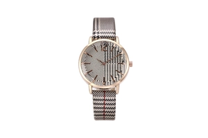 Macro shot of woman's quartz watch featuring houndstooth pattern and golden metal case