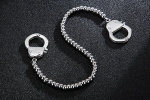 Detail of silver stainless steel chain bracelet featuring creative handcuff links