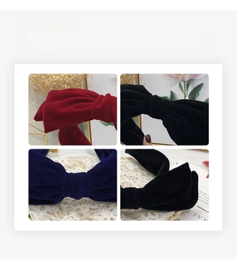 Detail showing velvet bow headbands in red, black, and navy with textured fabric finish