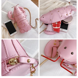 Detailed view of pink lobster-shaped crossbody bag with gold chain and interior storage