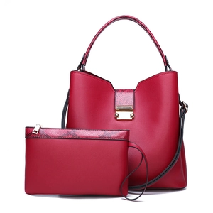 Red leather tote bag and pouch set with black snakeskin embossed handles and gold hardware