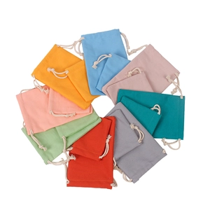 Colorful cotton drawstring pouches in various sizes and colors on white background