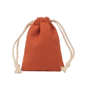 Detailed view of the orange cotton drawstring bag texture and double-rope closure design