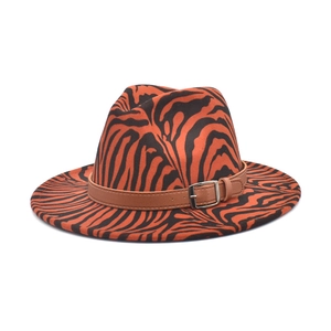 Detail of orange and black zebra print fedora hat with brown faux leather buckle strap