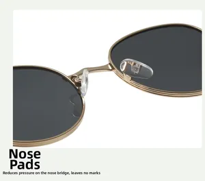 Detail of adjustable silicone nose pads on gold metal sunglasses for comfort