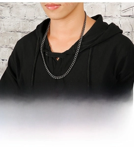Detail of matte black stainless steel Cuban link necklace worn on neck by male model