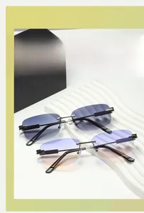 Close-up of rimless gradient sunglasses with metal bridge and sleek silver temples