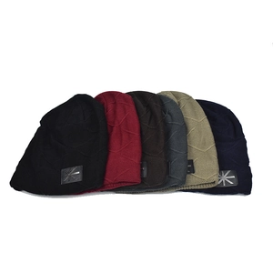 Set of six colorful fleece-lined winter knit beanies with textured patterns and leather tags