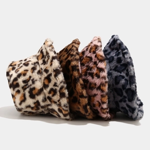 Close-up of fluffy leopard print bucket hats in beige brown pink and grey blue