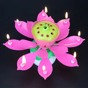 Blooming pink lotus musical birthday candle with eight lit flames on a rotating stand
