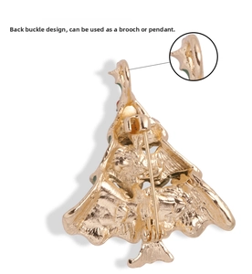 Dual-purpose gold Christmas tree brooch showing the back pin and necklace pendant loop detail
