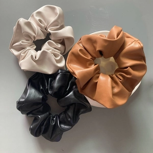 Three premium PU leather scrunchies in beige, black and brown with pleated texture