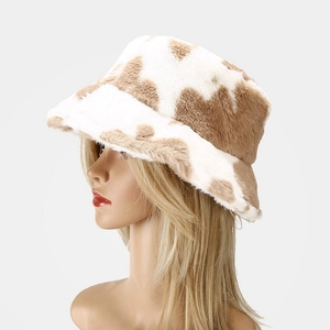 Side view of plush cow print bucket hat showing soft faux fur texture and brim detail