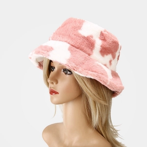 Pink cow print plush bucket hat for women in soft faux fur with warm thermal lining