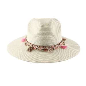 Dettaglio del cappello di paglia con nappe bohémien e ciondoli di conchiglia