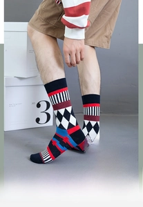 Detail shot of men's crew socks featuring navy blue cotton and geometric knit patterns
