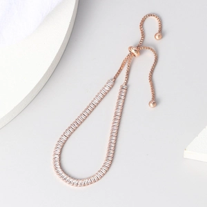 Elegant rose gold adjustable bracelet featuring rectangular zircon crystals on grey background