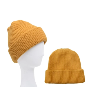 Mustard yellow knit beanie for winter featuring a vertical ribbed pattern and cozy design
