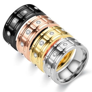 Macro view of titanium steel rings set in four colors with sparkling cubic zirconia