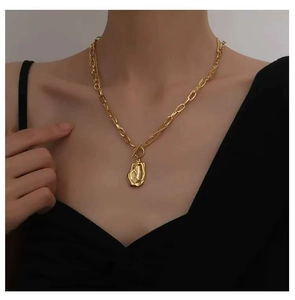 Detailed view of a gold T-bar toggle necklace with an irregular textured metal pendant