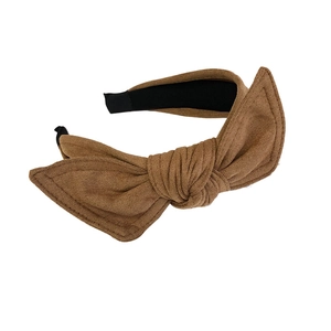 Minimalist velvet bow headband in light brown suede finish on a clean white background