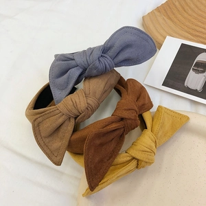 Detailed set of four velvet bow headbands in blue-grey, brown, and ginger yellow colors