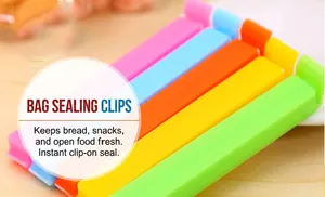 Five colorful 11cm plastic sealing clips in pink, blue, orange, yellow, and green on wood