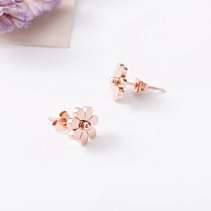 Close-up of rose gold sunflower earrings with six petals and polished butterfly backs