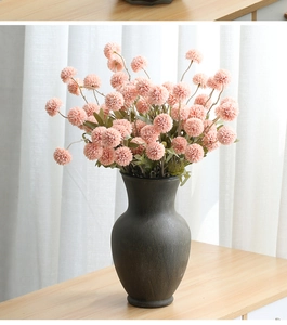 Pink artificial dandelion globes in a black ceramic vase for modern home table decor