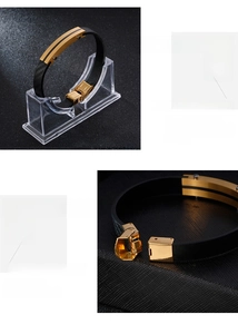 Detail of black leather braided bracelet with gold metal plate and carbon fiber inlay