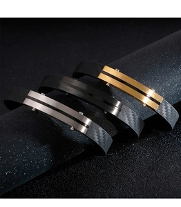 Detailed macro of stainless steel bracelets with carbon fiber texture in gold black and silver
