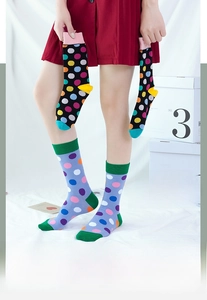 Detailed view of women mid-calf cotton socks with colorful polka dots and contrast heels