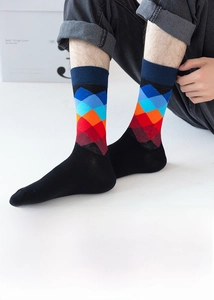 Primo piano dettagliato di calze da uomo con motivi geometrici a rombi colorati in cotone