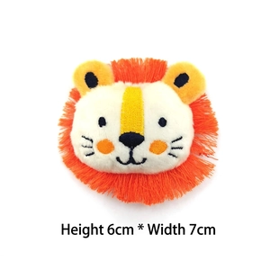 Detail of 6x7cm plush lion doll accessory with orange mane and soft embroidered features