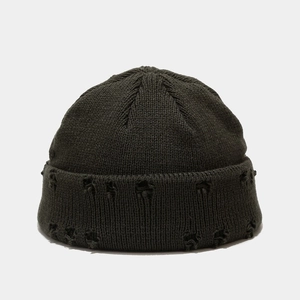 Detailed view of the distressed knit beanie with ribbed texture and ripped brim details