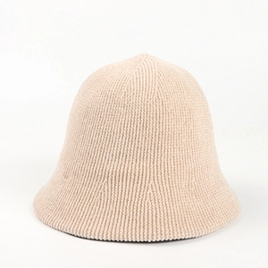 Close-up of beige chenille knit bucket hat showing thick vertical ribbed texture