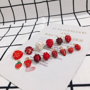 Macro shot of 3D red enamel strawberry charms for DIY jewelry making and crafts