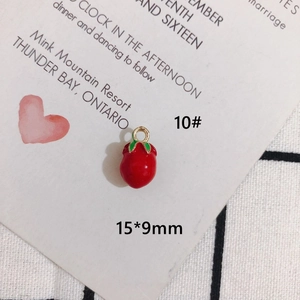Detail of red strawberry charm with green leaves and gold ring, size 15x9mm for DIY