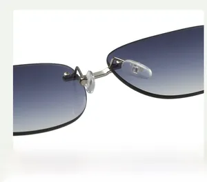 Detail of rimless sunglasses featuring gradient blue lenses and adjustable nose pads