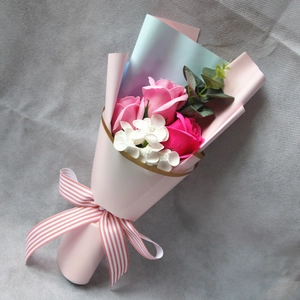 Top view of pink and magenta soap rose bouquet with eucalyptus in gift wrapping