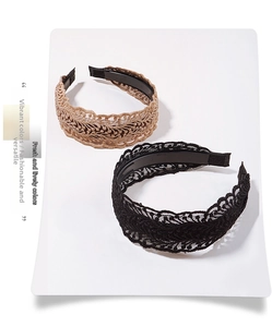 Detailed view of non-slip inner teeth and lace texture on black and brown headbands
