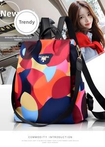 Close-up of the POABA metal logo on a colorful waterproof nylon patchwork backpack