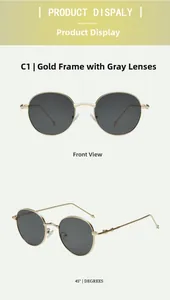 Detail of vintage round metal sunglasses in gold frame with dark grey polarized lenses