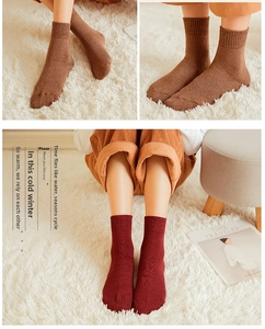 Close-up of thick winter knit wool socks in brown and burgundy with ribbed cuffs