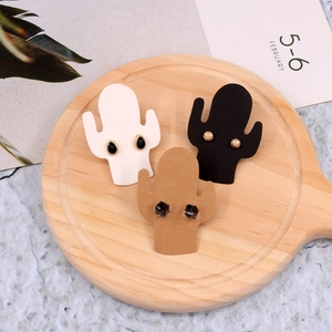 Three pairs of stylish earrings displayed on cactus-shaped jewelry backing cards