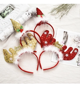 Close-up of reindeer antler headband with Merry Christmas text and snowflake patterns