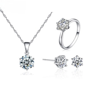 Detailed view of silver jewelry set with six-prong round zircon necklace ring and earrings