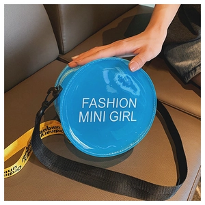 Detail of blue laser jelly round bag with Fashion Mini Girl text and nylon strap