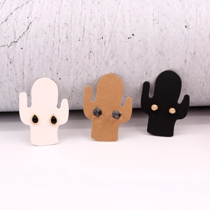 Three pairs of stud earrings displayed on cactus-shaped paper cards in black white and brown