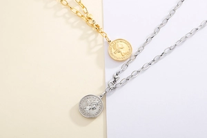 Detailed close-up of gold and silver coin pendant necklaces with relief portraits
